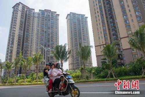 資料圖：市民在?？谑袇^(qū)某地產(chǎn)項目前路過。 中新社記者 駱云飛 攝